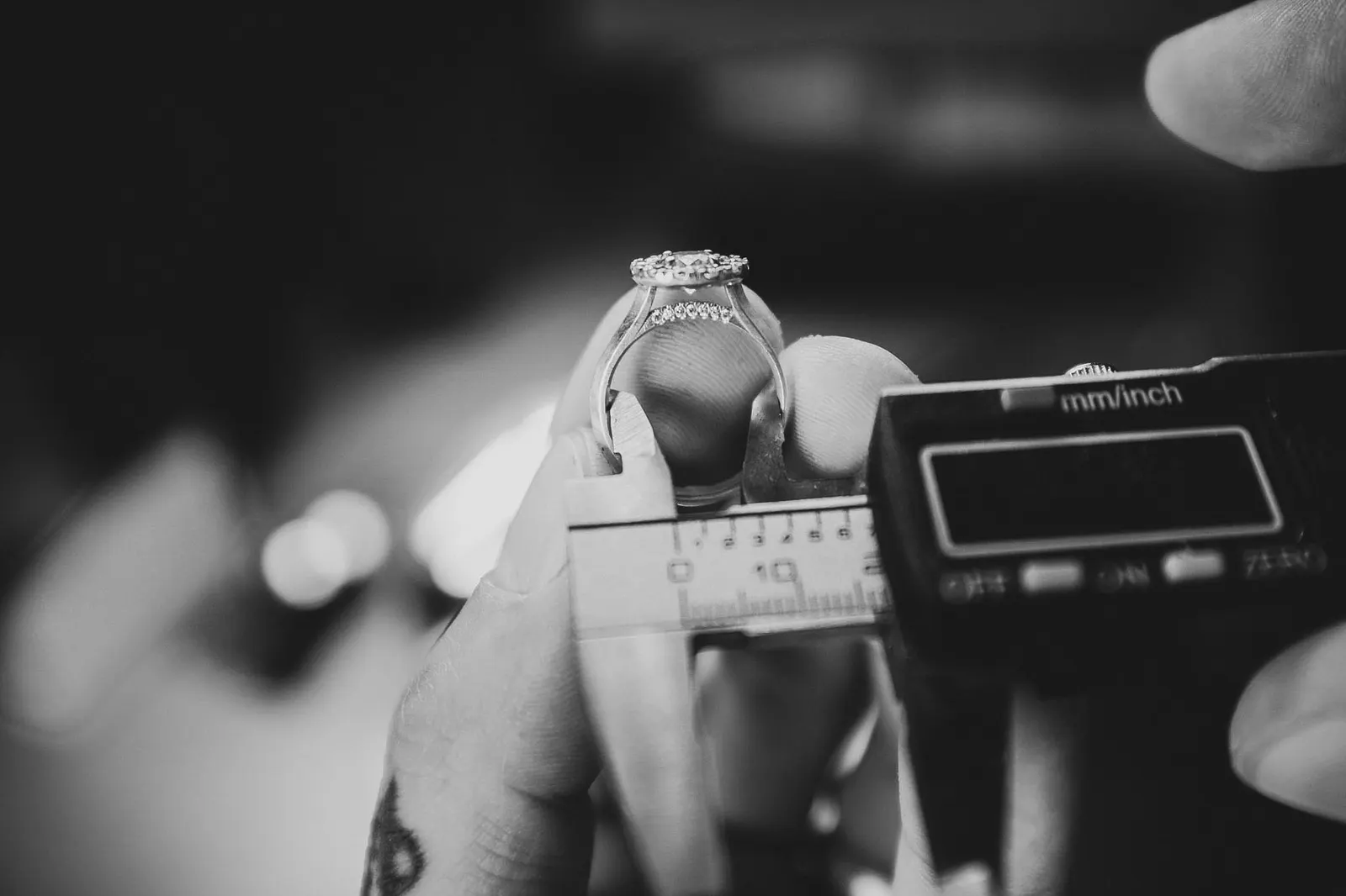 Measuring a ring's inner diameter with callipers at the bench
