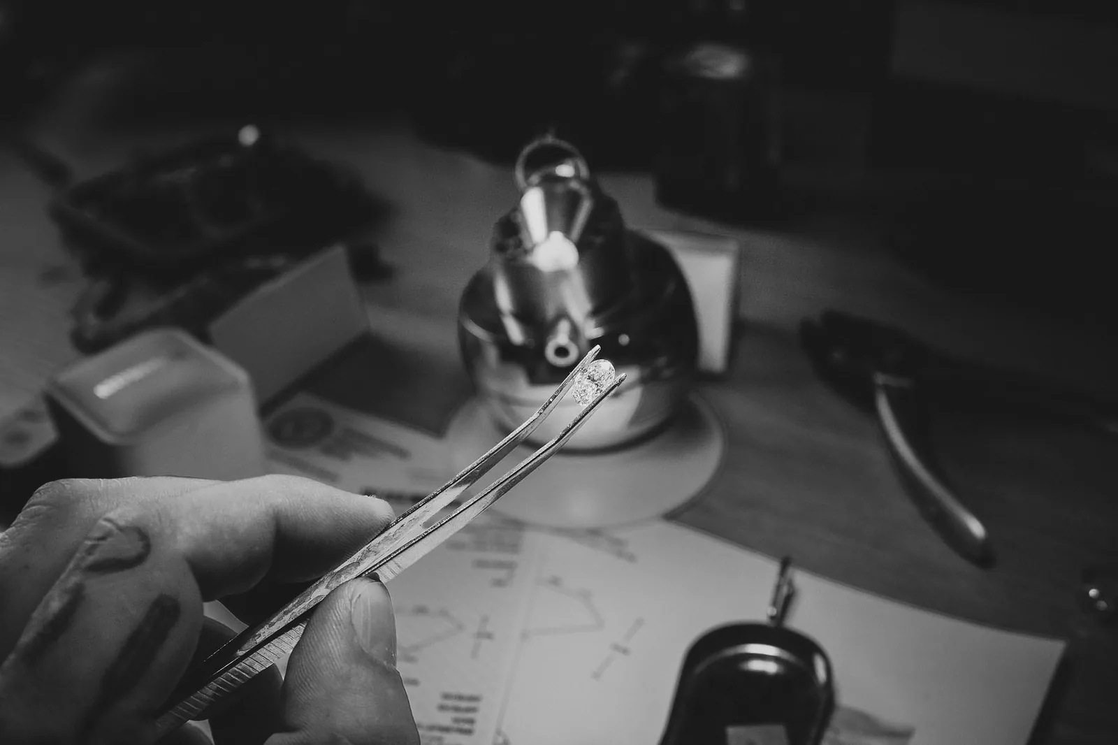 A diamond held in tweezers during selection